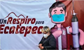  ?? Pedro Pardo/AFP/Getty Images ?? A woman queues for oxygen tanks in Ecatepec, Mexico. In December, as Covid cases soared, the national guard were brought in to protect lorries delivering oxygen supplies. Photograph: