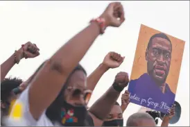  ?? Photo: Nampa/AFP ?? Battling on… People raise their fists and hold a portrait of George Floyd during a rally following the guilty verdict the trial of Derek Chauvin.