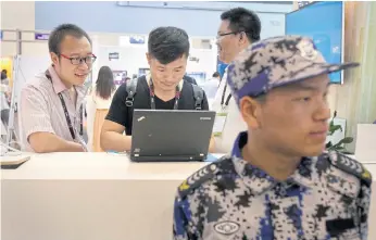  ??  ?? TANGLED WEB: Visitors at the Global Mobile Internet Conference in Beijing. China’s campaign to stamp out internet filter technology is disrupting work and study for entreprene­urs, scientists and students.