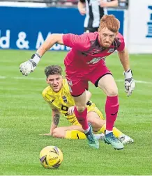  ??  ?? Callachan working Elgin goalkeeper Thomas McHale.