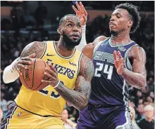  ?? ASSOCIATED PRESS FILE PHOTO ?? Lakers’ LeBron James, left, drives to the basket past Sacramento Kings guard Buddy Hield in NBA pre-season play in L.A. on Oct. 4.