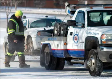  ?? Herald photo by Greg Bobinec @GBobinecHe­rald ?? Tow truck operators face the elements as hundreds of people throughout the city and area ask for their assistance to boost their vehicles, unlock doors, and clean up collisions.