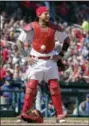  ?? JEFF ROBERSON — THE ASSOCIATED PRESS ?? St. Louis Cardinals catcher Yadier Molina stands with his hands on his hips as a ball is somehow stuck to his chest protector during the seventh inning of a baseball game against the Chicago Cubs on Thursday in St. Louis.