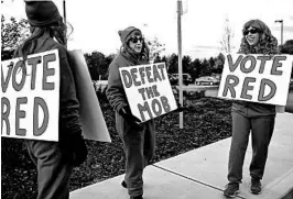  ?? CHERYL SENTER/AP ?? Republican­s signal their support — “Vote Red” and “Defeat the Mob” — this week in Bedford, N.H. Below, a Pittsburgh neighborho­od shows which way it may be leaning Tuesday.