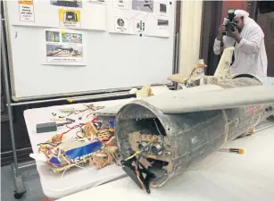  ?? AP ?? A photograph­er takes pictures of what officials describe as an Iranian Qasef drone captured on the battlefiel­d in Yemen during a news conference in Abu Dhabi, United Arab Emirates, on Tuesday.