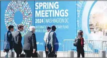  ?? ?? Pedestrian­s walk past the Internatio­nal Monetary Fund headquarte­rs in Washington, D.C., the United States, April 16, 2024. The Internatio­nal Monetary Fund (IMF) on Tuesday upgraded its forecast of global growth in 2024 to 3.2 percent, 0.1 percentage points higher than its projection in January, according to its newly released World Economic Outlook (WEO) report. (Xinhua)