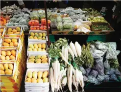  ??  ?? LONDON: Fruit and vegetables are displayed for sale at a food stall at Whitechape­l Market in east London yesterday. — AFP