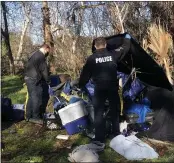  ?? NATALIE HANSON — ENTERPRISE-RECORD ?? Officer Ed Nelson, left, and Sgt. Paul Ratto dismantle a tent Tuesday along Little Chico Creek in Chico.