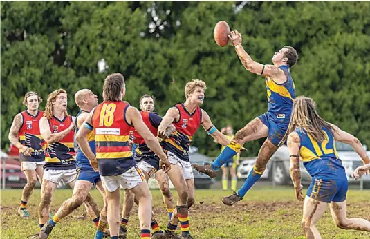  ?? Photograph­s Fearghus Browne. ?? Ellinbank’s Tom Johnson flies for the ball in the third quarter against Longwarry on Saturday.