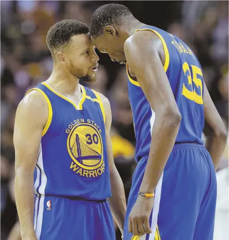  ?? AP PHOTO ?? HEADING OFF THE CHAMPS: Stephen Curry (left) and Kevin Durant celebrate after the Warriors scored the final 11 points to rally and stun the Cavaliers, 118-113, in last night’s Game 3 of the NBA Finals in Cleveland.