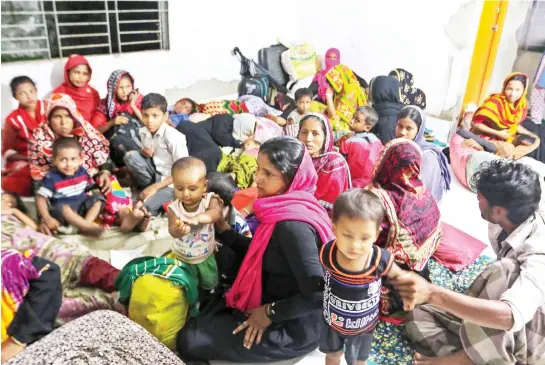  ??  ?? Bangladesh­i villagers take refuge in a cyclone shelter after being evacuated from the coastal villages of the Cox’s Bazar district. (AFP)