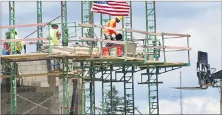  ?? (AP PHOTO/KEITH SRAKOCIC, FILE) ?? In this June 11, 2020 file photo, workers on scaffoldin­g lay blocks on one of the larger buildings at a developmen­t site where various residentia­l units and commercial sites are under constructi­on in Cranberry Township, Butler County, Pa. U.S. productivi­ty rose at a 7.3% rate in the second quarter, the largest quarterly increase since 2009. Labor costs also jumped, rising 12.2%. The Labor Department report Friday, Aug. 14, is its first estimate of second-quarter productivi­ty and follows the first quarter’s 0.9% decline.