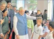  ?? PTI ?? Prime Minister Narendra Modi interacts with children in Manila on Monday during a visit to a philanthro­pist organisati­on that provides free Indianmade prosthesis, ‘Jaipur Foot’, to amputees .