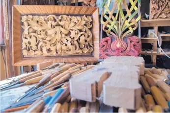  ??  ?? Intricate wood carvings hang in Ivan Dimitrov’s Santa Fe garage studio.