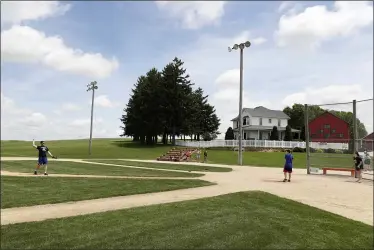  ?? CHARLIE NEIBERGALL — THE ASSOCIATED PRESS ?? Visitors play on the field at the Field of Dreams movie site June 5in Dyersville, Iowa.