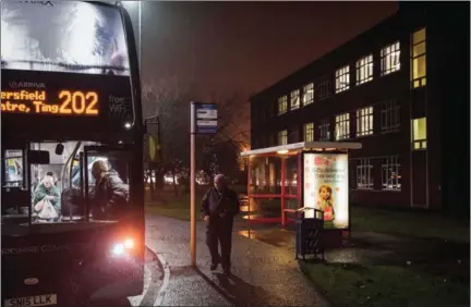  ?? PHIL HATCHER-MOORE/THE NEW YORK TIMES ?? A man boards a bus outside the offices of the Syngenta Manufactur­ing Centre on December 15.