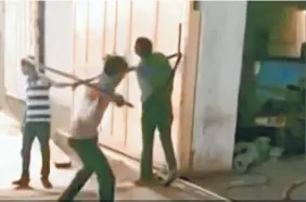  ??  ?? A VIDEO GRAB of Mukesh Vania of Parnala village in Surendrana­gar district being beaten outside a factory in Shapar accusing him of theft, on May 20.