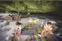  ??  ?? Mat weavers of Brgy. Basiao, Basey, Samar gather under the limestone cliff of Saub Cave.