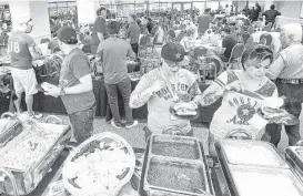  ?? J. Patric Schneider ?? A buffet was part of Group 1 Automotive’s recruiting event for auto technician­s during an Astros baseball game on Sunday. The company needs 350 technician­s.