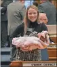  ?? THE ASSOCIATED PRESS ?? North Dakota state Rep. Emily O’brien. with her newborn last year, helped persuade her colleagues to approve $66 million in child care spending.