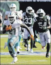  ?? Brad Penner The Associated Press ?? Frank Gore of the Dolphins, fourth in the NFL in career rushing with 14,412 yards, rambles for a gain on Sept. 16 against the New York Jets.