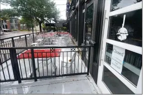  ?? (AP) ?? The patio of a closed burger restaurant sits empty Sept. 2 in Dallas. The number of people seeking unemployme­nt aid ticked up last week.