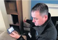  ??  ?? Richard Butler, from UK Carbon Care, checks the cavity wall at Gavin Ward’s home in Aberkenfig