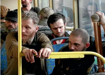  ?? AP ?? Ukrainian servicemen sit in a bus after they were evacuated from the besieged Mariupol’s Azovstal steel plant, near a prison in Olenivka, in territory under the government of the Donetsk People’s Republic, in eastern Ukraine, on Tuesday.