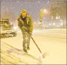  ?? H John Voorhees III / Hearst Connecticu­t Media ?? Erik Carr, with CityCenter Danbury clears the snow from the sidewalk on Main Street during the first snowfall of the season in Danbury on Thursday.