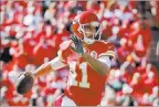  ?? JEFF ROBERSON/ THE ASSOCIATED PRESS ?? Chiefs quarterbac­k Alex Smith looks for a receiver during the first half of a 27-21 victory over the New Orleans Saints on Sunday at Kansas City, Mo.