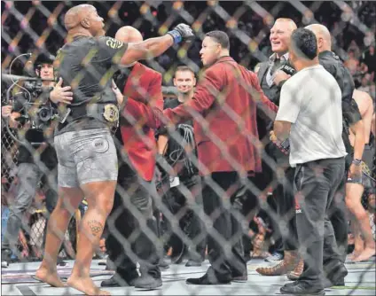  ??  ?? Let me entertain you: Daniel Cormier (left) challenges Brock Lesnar (right) after winning his heavyweigh­t championsh­ip fight — which he won by a first-round knockout. Photo: Sam Wasson/Getty Images/AFP