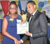  ??  ?? Minister of state in the Ministry of Education, Youth and Informatio­n, Floyd Green, presents the top Grade Six Achievemen­t Test Scholarshi­p awardee Assana Thompson with her certificat­e from the Jamaica Police Cooperativ­e Credit Union (JPCCU). Occasion...