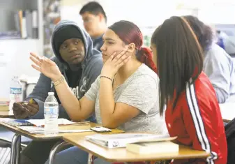  ?? Photos by Liz Hafalia / The Chronicle ?? Students Amoy Tomlin (left), America Sanchez and Cynthia Galvan at Castlemont High in the Oakland school district, which a study says lost $57.4 million last year due to charter schools.