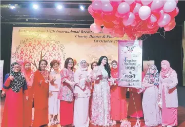  ??  ?? Raghad (fourth right) seen on stage after launching the breast cancer awareness month for the Pink Ribbon Support Group. Also seen are Sharifah Hasidah (fifth right), Suriani (third right) and other Pink Ribbon Support Group committee members.