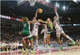  ?? NELL REDMOND/AP ?? Mississipp­i Valley State guard Leah Turner, left, looks on as South Carolina guard Bree Hall, second from left, and forward Sania Feagin, right, battle Mississipp­i Valley State forward SyAnn Holmes for a rebound during the second half Friday.