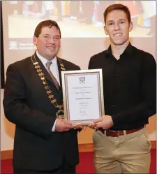  ??  ?? Cathaoirle­ach of Sligo County Council, Cllr. Martin Baker making a presentati­on to Jason McGuinness who was 1st Fiddle Slow Airs at the All Ireland Fleadh.