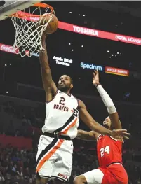  ?? (Richard Mackson-USA TODAY Sports/TNS) ?? LOS ANGELES Clippers forward Kawhi Leonard moves in ahead of Portland Trail Blazers guard Kent Bazemore during the second half at Staples Center on Tuesday.