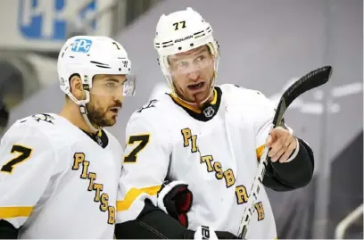  ?? Associated Press ?? Jeff Carter, right, talking with Colton Sceviour, made his Penguins debut Thursday against the Flyers and showed an ability to play fast and physical.