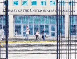  ?? Emily Michot Miami Herald ?? WORKERS at the U.S. Embassy in Havana exit the building after the State Department announced that it was pulling nonessenti­al personnel in September.