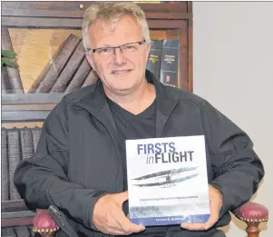  ?? ELIZABETH PATTERSON/CAPE BRETON POST ?? Author Terrance MacDonald shows his latest book, “Firsts In Flight,” which will be officially launched at the Alexander Graham Bell Museum today.