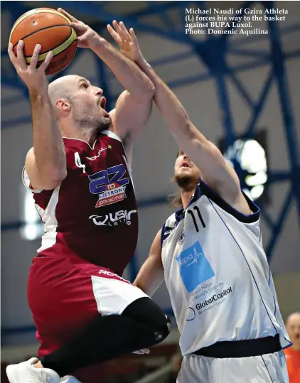  ?? Photo: Domenic Aquilina ?? Michael Naudi of Gzira Athleta (L) forces his way to the basket against BUPA Luxol.