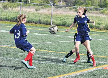  ?? DESIREE ANSTEY/ JOURNAL PIONEER ?? Lauren Mintie, left, and Alex MacCaull of the host Summerside United Soccer Club (SUSC) unite to defend against an opponent from Fredericto­n, N.B., club in the SUSC’s recent under-13 and under-11 boys and girls soccer tournament in Summerside. The...
