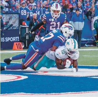  ?? MATT DURISKO/ AP ?? Miami Dolphins wide receiver Tyreek Hill catches a two-point conversion in front of Buffalo Bills cornerback Tre’Davious White during a wild-card game on Jan. 15 in Orchard Park, NY.