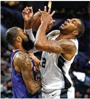  ?? RONALD CORTES / AP ?? LaMarcus Aldridge, a former Texas Longhorn, is fouled by the Suns’ Tyson Chandler on the way to scoring 21 points in Sunday’s victory in San Antonio.