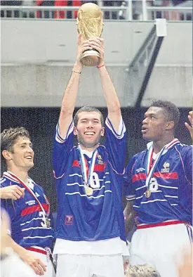  ??  ?? France’s Zidane lifts the Fifa World Cup trophy in 1998. LEFT
