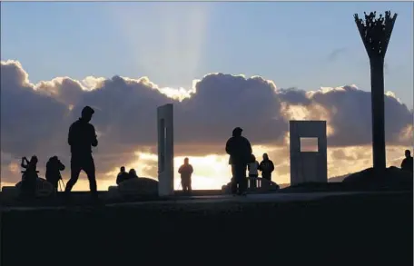  ?? Glenn Koenig
Los Angeles Times ?? PEOPLE take in the sunset at Hilltop Park in Signal Hill on Friday. About a tenth of an inch of rain is expected in the area Saturday as a cold front moves in from the north. The bulk of the rain is expected to fall along the Central Coast.