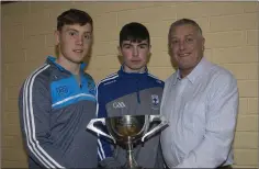  ??  ?? Con O’Callaghan with Blessingto­n under-15 Player of the Year award winner Oisin Brogan with the Pat Fanning Cup presented by Tom Hennessy at the club’s recent awards night.