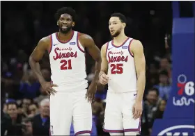  ?? MATT SLOCUM - THE ASSOCIATED PRESS ?? The Philadelph­ia 76ers’ Ben Simmons, right, and Joel Embiid talk during an NBA game against the New Orleans Pelicans, Friday, in Philadelph­ia.