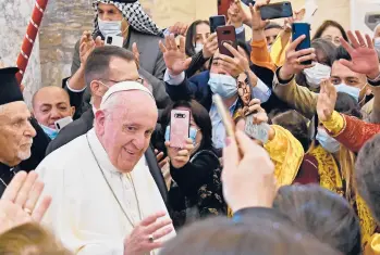  ?? VINCENZO PINTO/GETTY-AFP ?? A crowd flocks to Pope Francis as he arrives Sunday at the Church of the Immaculate Conception in Qaraqosh, Iraq. Francis wrapped up the day — and his visit to Iraq— with a Mass at the stadium in Irbil.