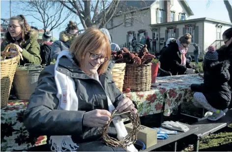  ?? MICHELLE ALLENBERG/ WELLAND TRIBUNE ?? Melanie Stansfield creates wreaths for people to decorate during the annual Grand Old Christmas Festival at Port Colborne Historical and Marine Museum Sunday